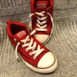 Red worn size five boys all-star Chuck Taylor converse shoes.